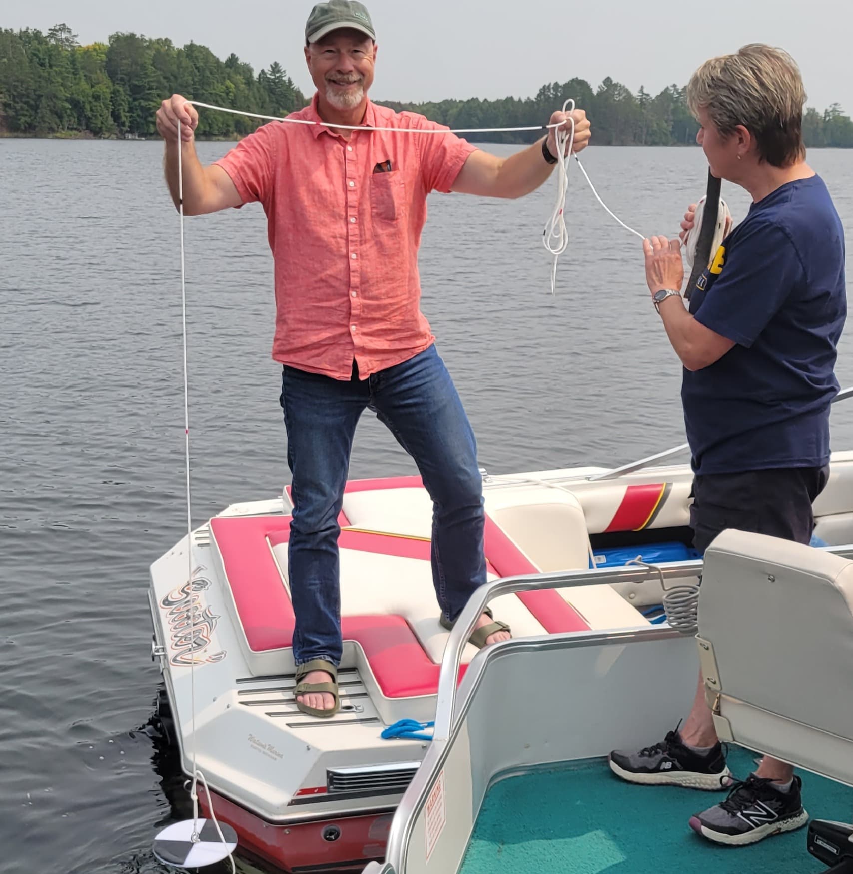 Person holding up a secchi disk